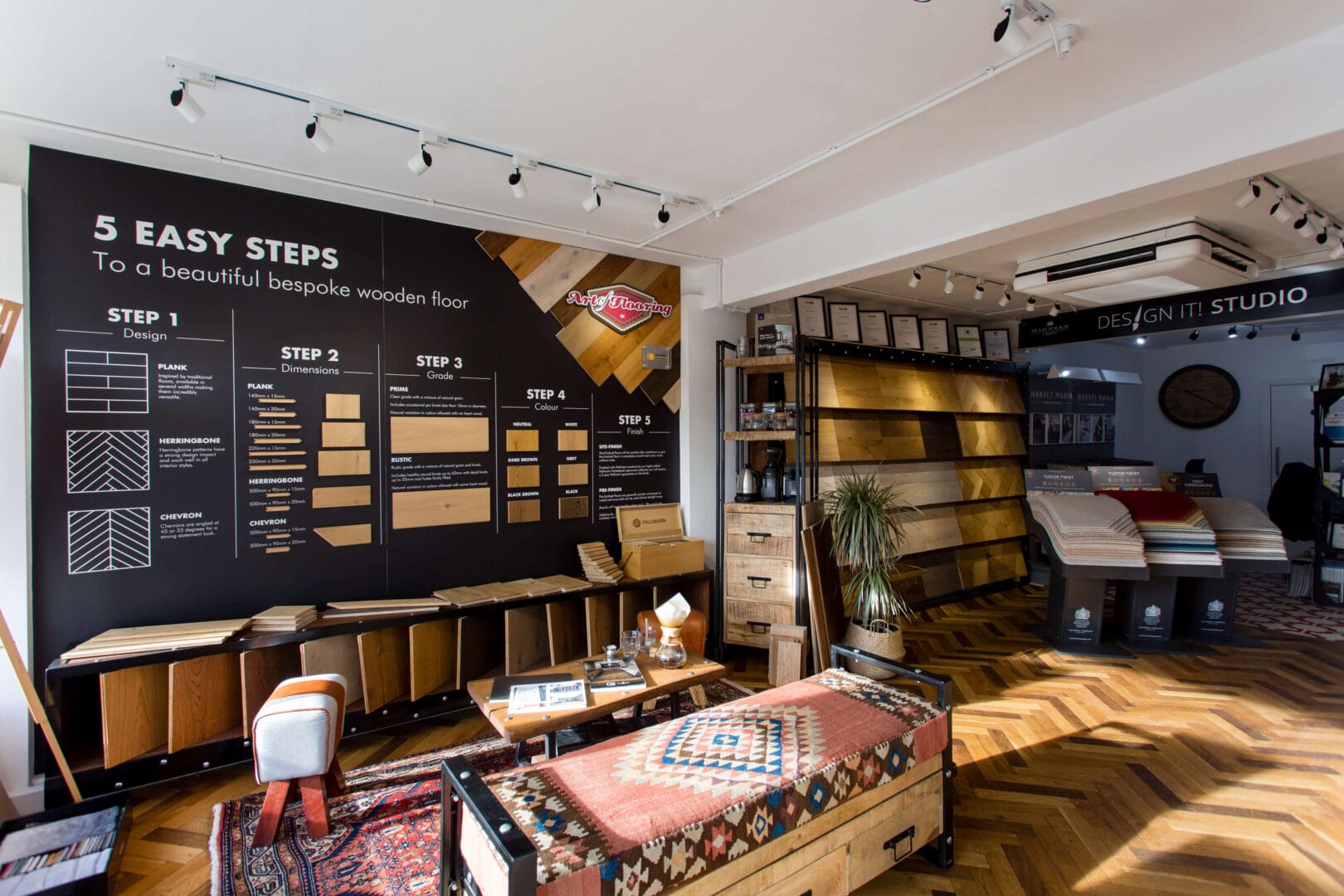 Interior of the Art of Flooring Cambridge showroom with wood flooring displays and carpet samples.