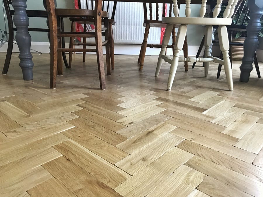 Oak herringbone flooring installed in a Cambridge lounge area.