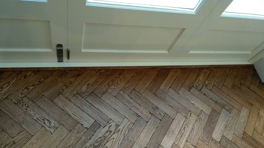 Oak herringbone parquet flooring restored and refinished in a Cambridge home.