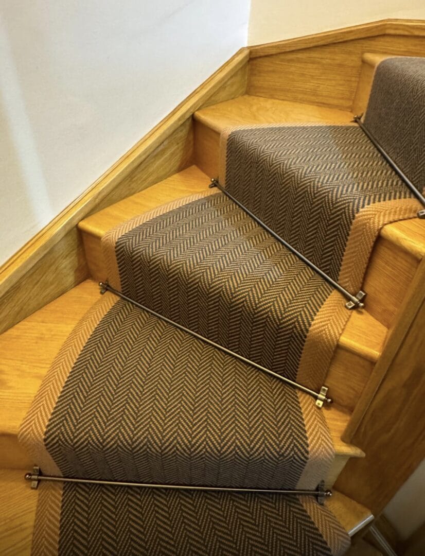 Close-up of herringbone carpet runner on oak stairs in Cambridge, showing a durable weave that stays comfortable underfoot