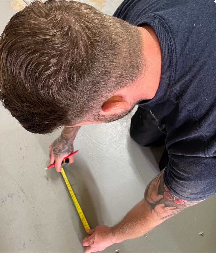 Measuring subfloor before LVT flooring installation in Cambridge