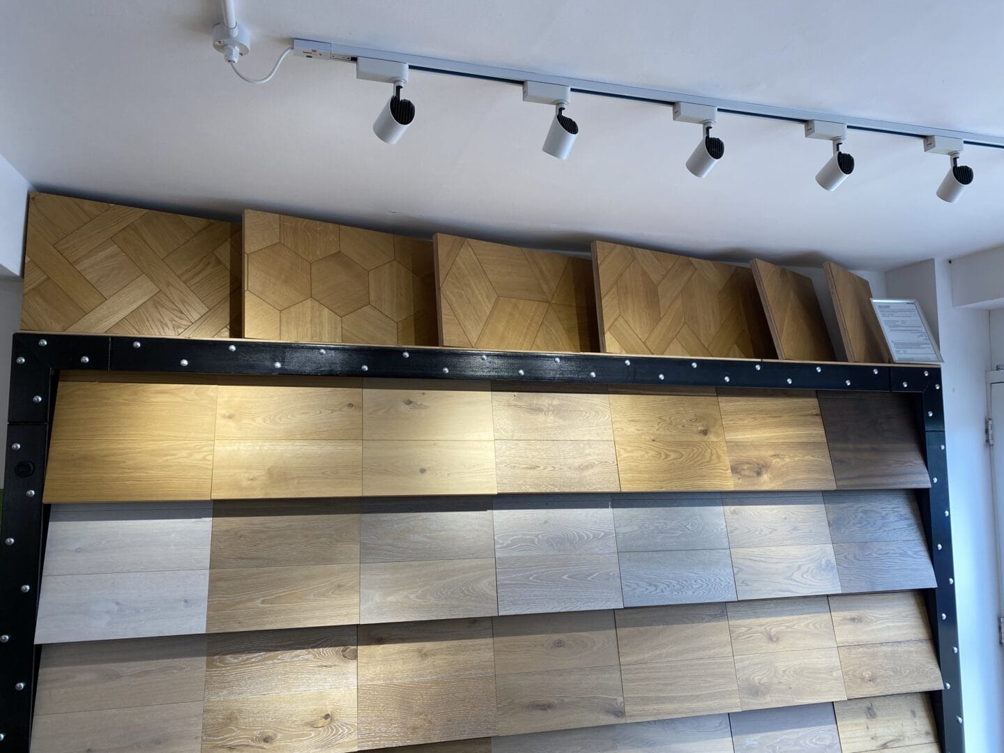 Engineered oak flooring samples displayed on a showroom wall in Cambridge