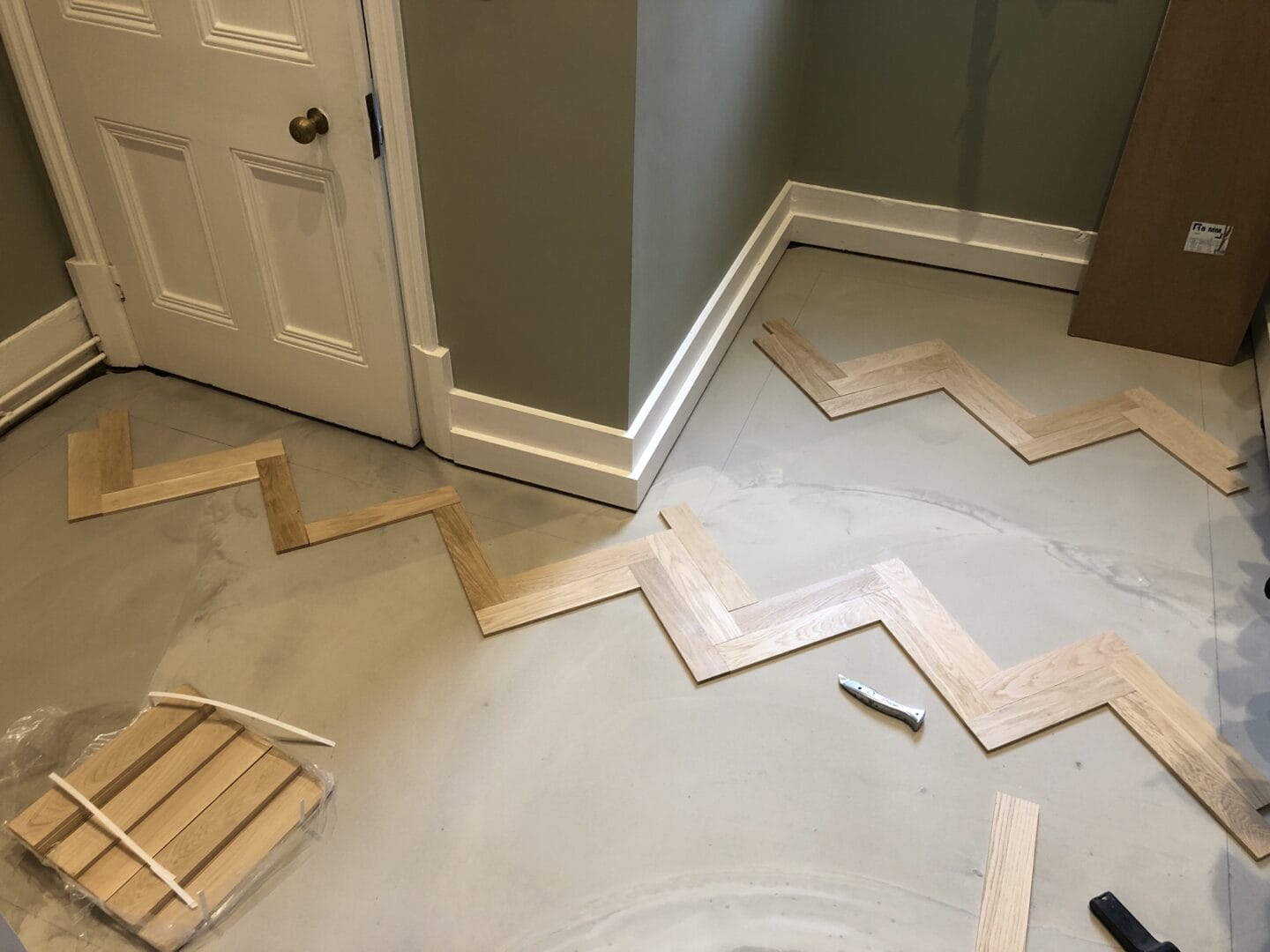 Herringbone wood flooring layout being set out before installation in a Cambridge home