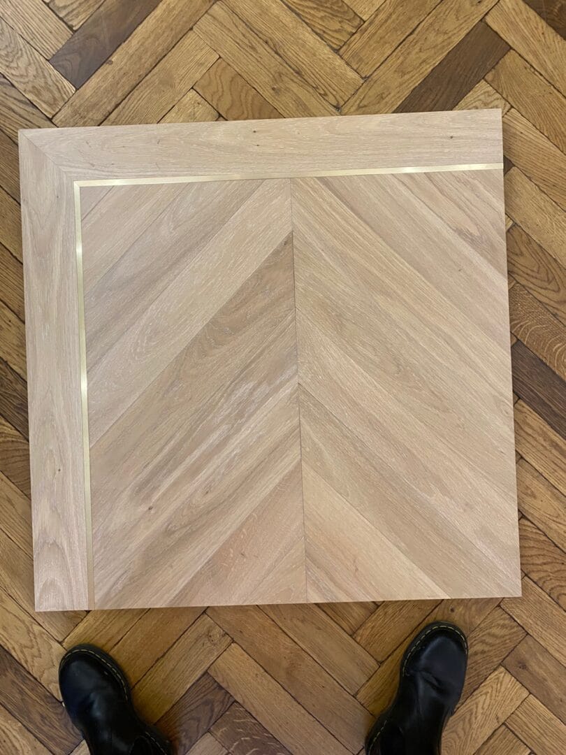 Engineered oak chevron flooring sample panel displayed during flooring selection in Cambridge.
