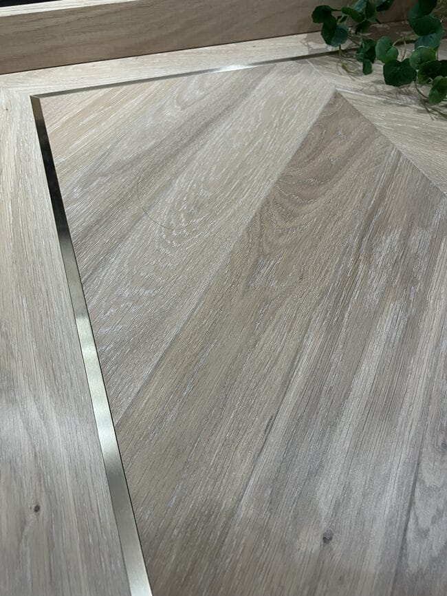 Oak wood flooring with metal border in a Cambridge home
