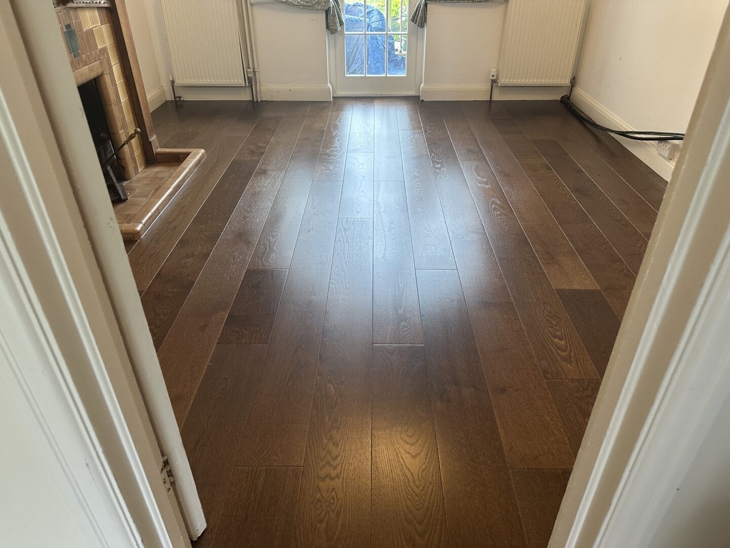 Completed walnut engineered flooring across a living room in Cambridge
