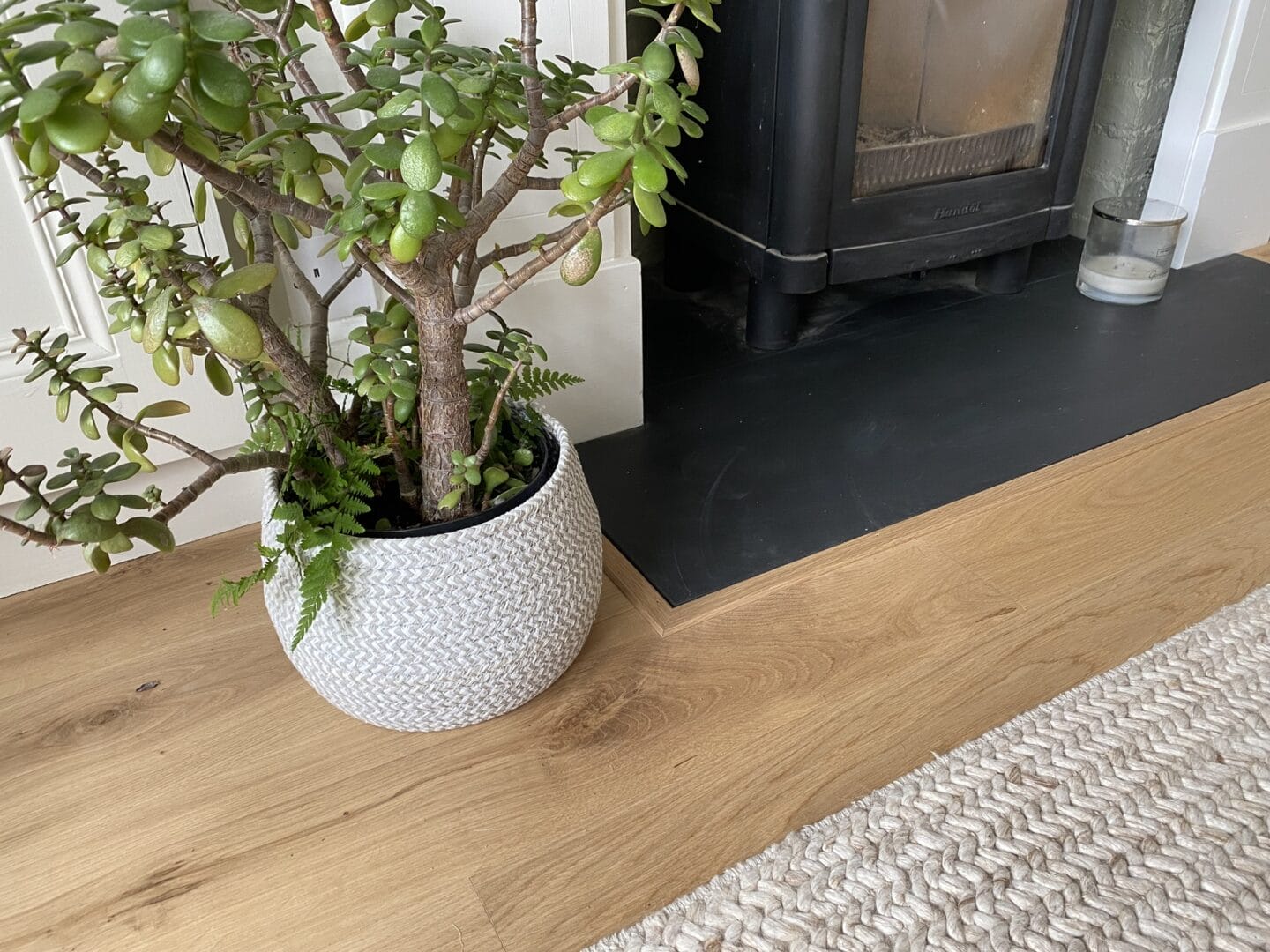 Maple engineered flooring fitted neatly around a fireplace in Cambridge