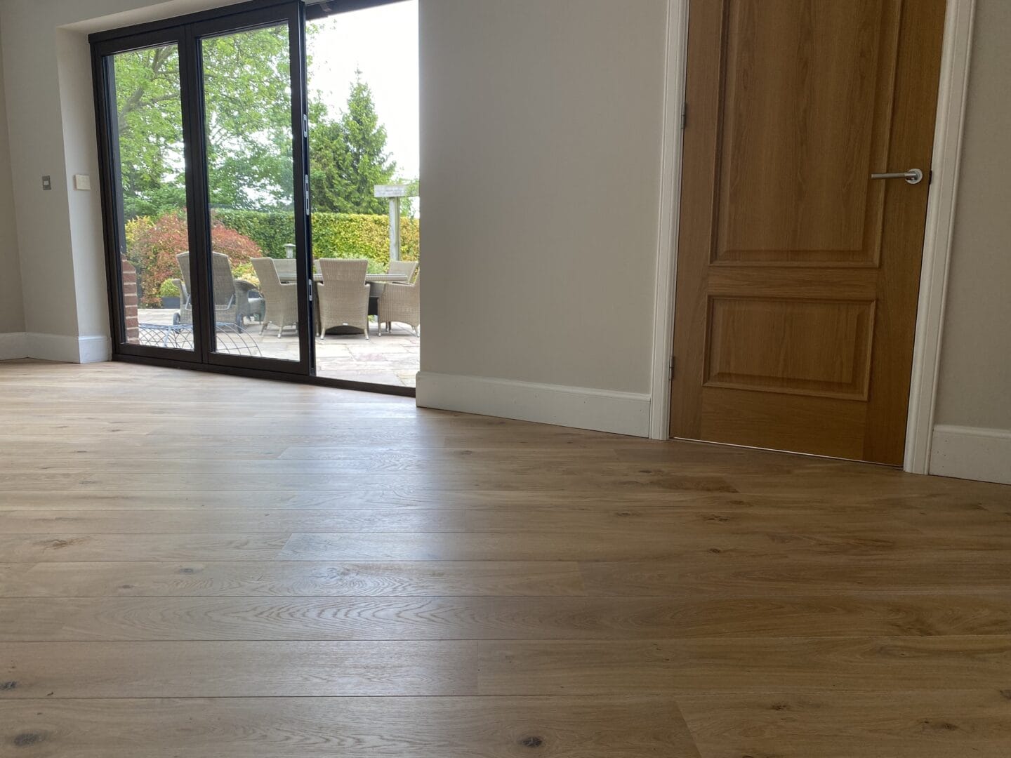 Maple engineered flooring installation beside garden doors in a Cambridge home