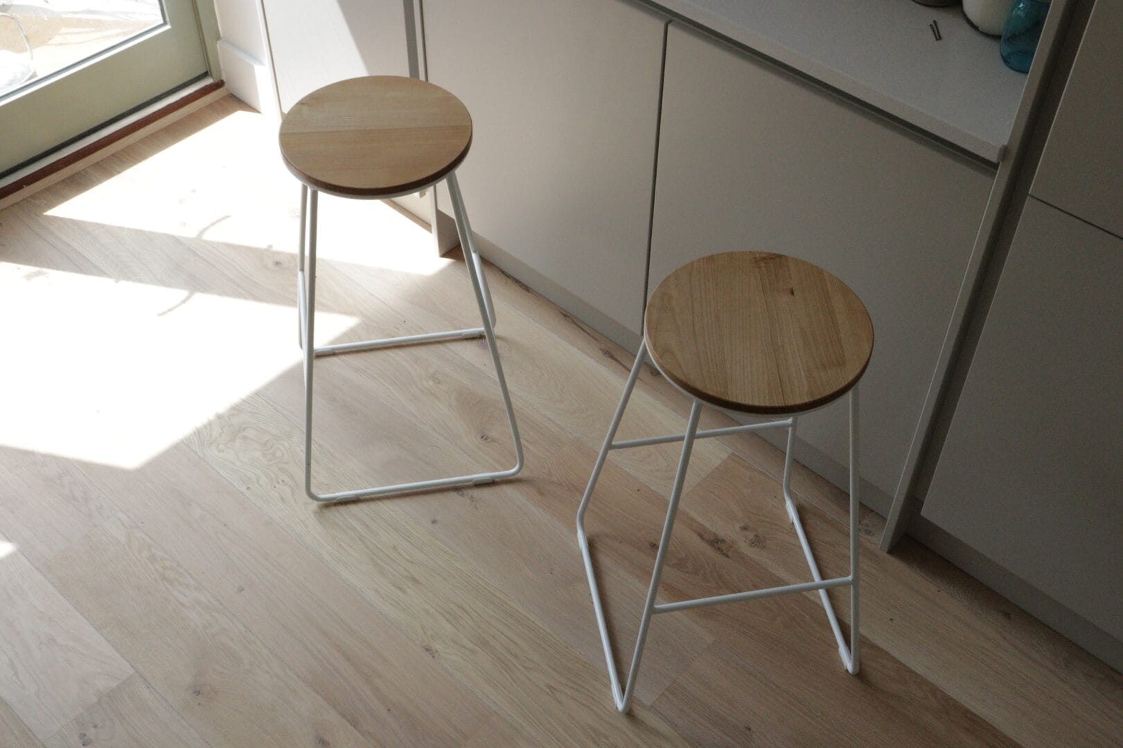 Maple engineered wood flooring in a bright Cambridge kitchen with breakfast stools